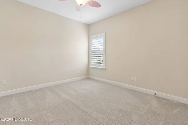 a bathroom with a granite countertop tub sink and mirror
