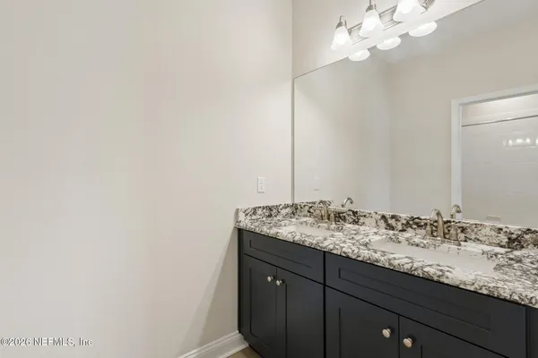 an empty room with ceiling fan and window