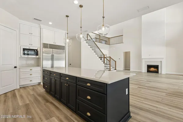 a kitchen with a sink stainless steel appliances and cabinets