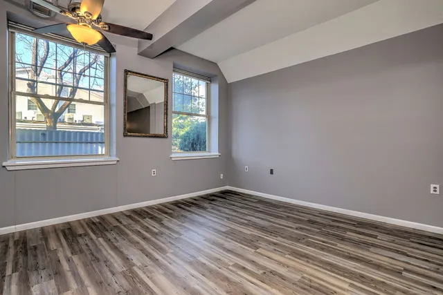 wooden floor in an empty room with a window