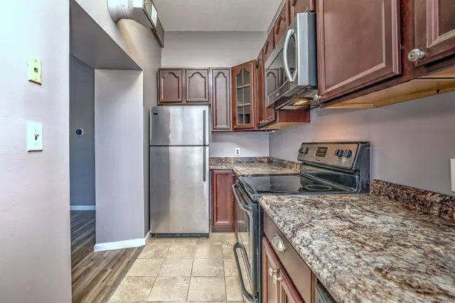 a kitchen with a stove and a refrigerator
