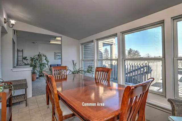 a dining room with furniture window and wooden floor