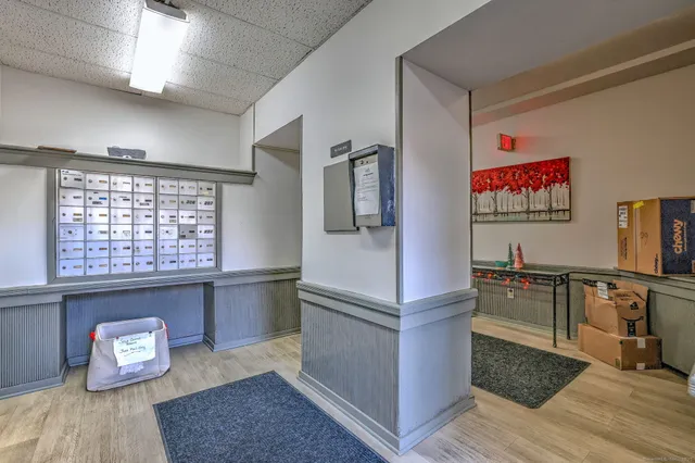 a kitchen with a refrigerator and a wooden floor