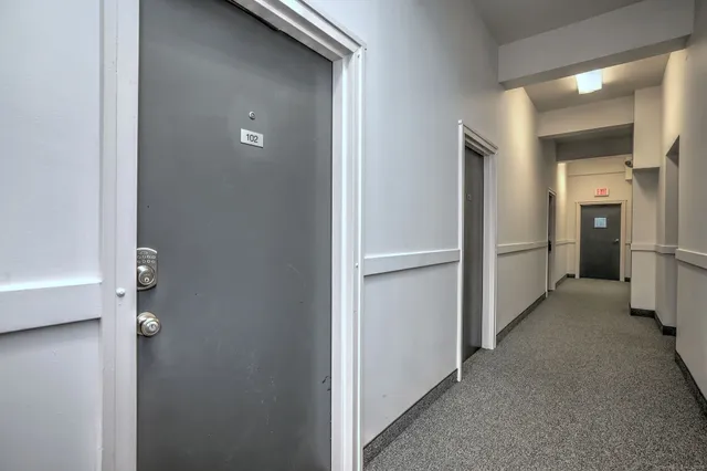 a view of a hallway with a refrigerator