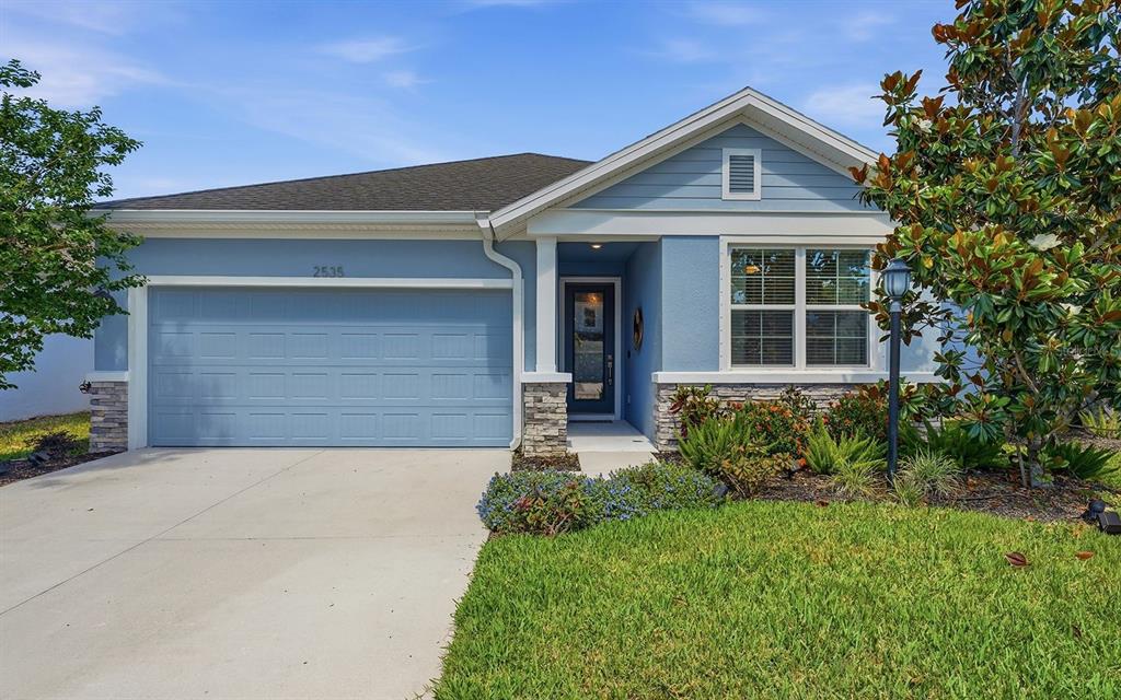 2535 Fireflag Lane Sarasota, FL 34232 - Photo 1 of 27 a front view of a house with garden