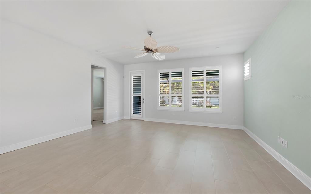 2535 Fireflag Lane Sarasota, FL 34232 - Photo 13 of 27 an empty room with windows and ceiling fan