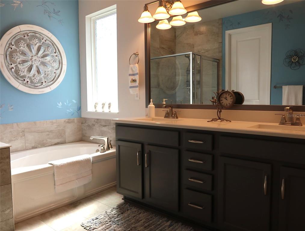 2535 Fireflag Lane Sarasota, FL 34232 - Photo 13 of 17 a bathroom with a double vanity sink mirror and bathtub