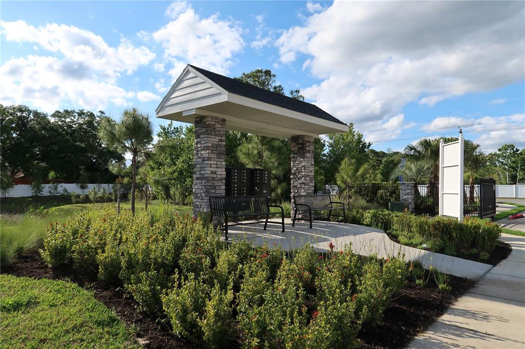 2535 Fireflag Lane Sarasota, FL 34232 - Photo 2 of 17 a view of a patio with table and chairs under an umbrella