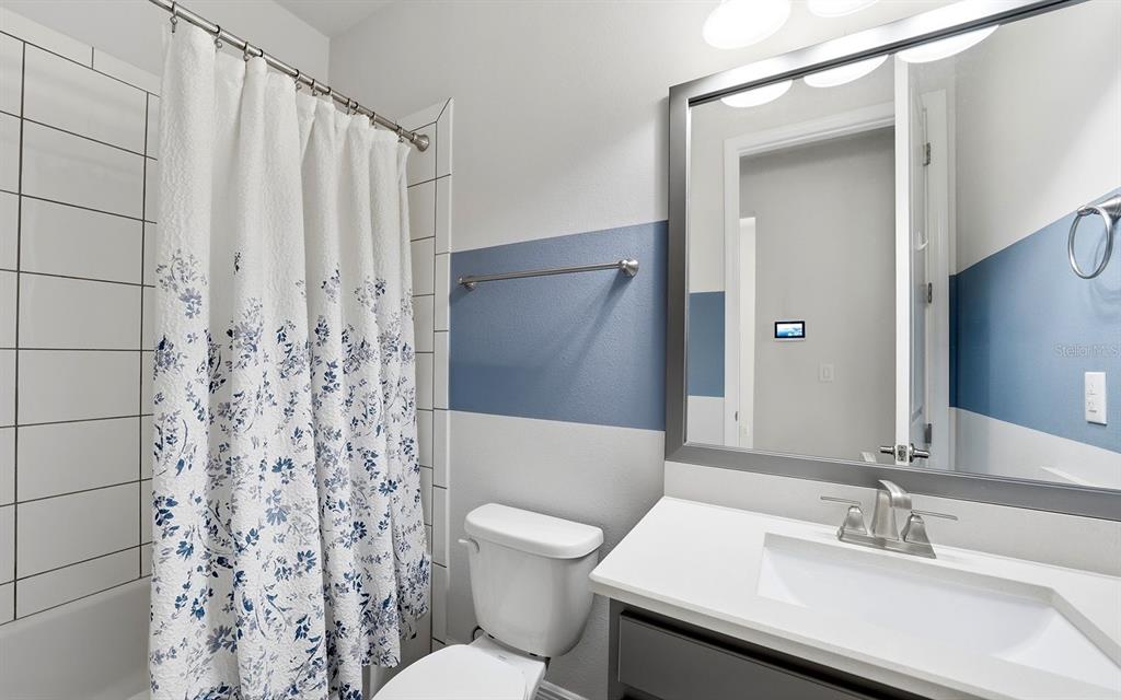 2535 Fireflag Lane Sarasota, FL 34232 - Photo 22 of 27 a bathroom with a sink and a mirror