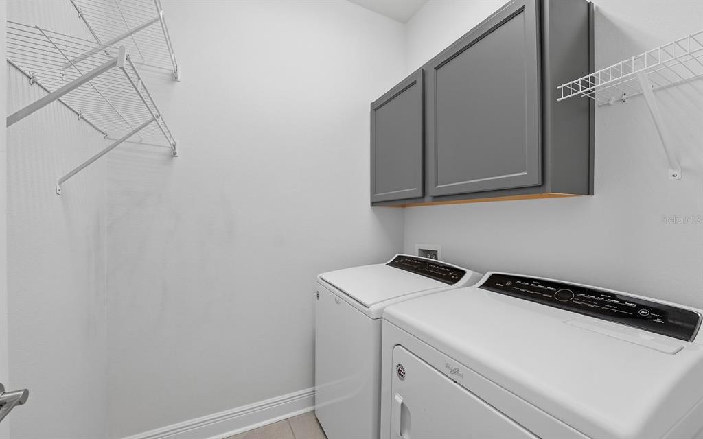 2535 Fireflag Lane Sarasota, FL 34232 - Photo 23 of 27 a utility room with dryer and washer