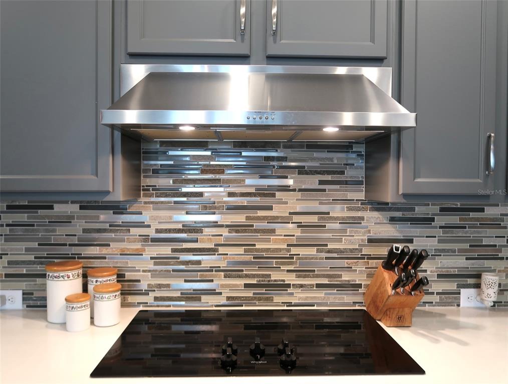 2535 Fireflag Lane Sarasota, FL 34232 - Photo 7 of 17 a kitchen with kitchen island a stove and a counter top