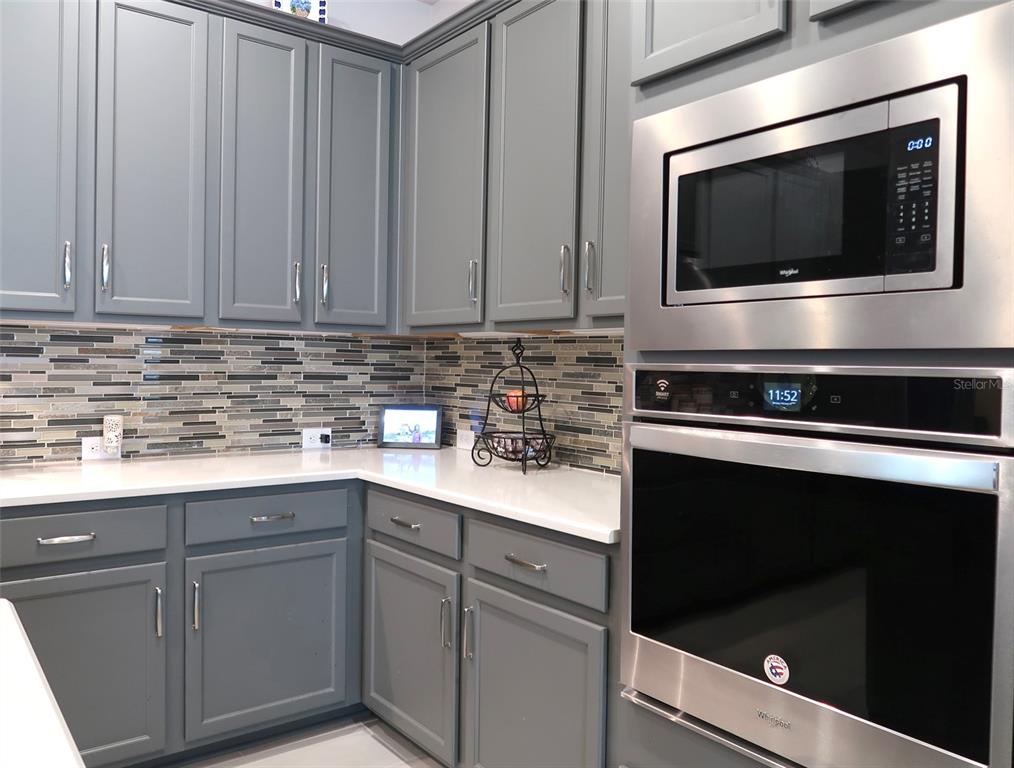 2535 Fireflag Lane Sarasota, FL 34232 - Photo 8 of 17 a kitchen with microwave cabinets and stainless steel appliances
