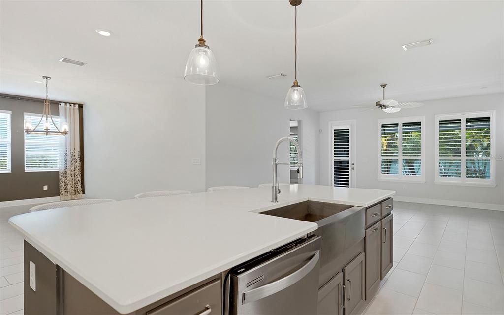 2535 Fireflag Lane Sarasota, FL 34232 - Photo 8 of 27 a kitchen with stainless steel appliances granite countertop a sink a stove and a wooden floors