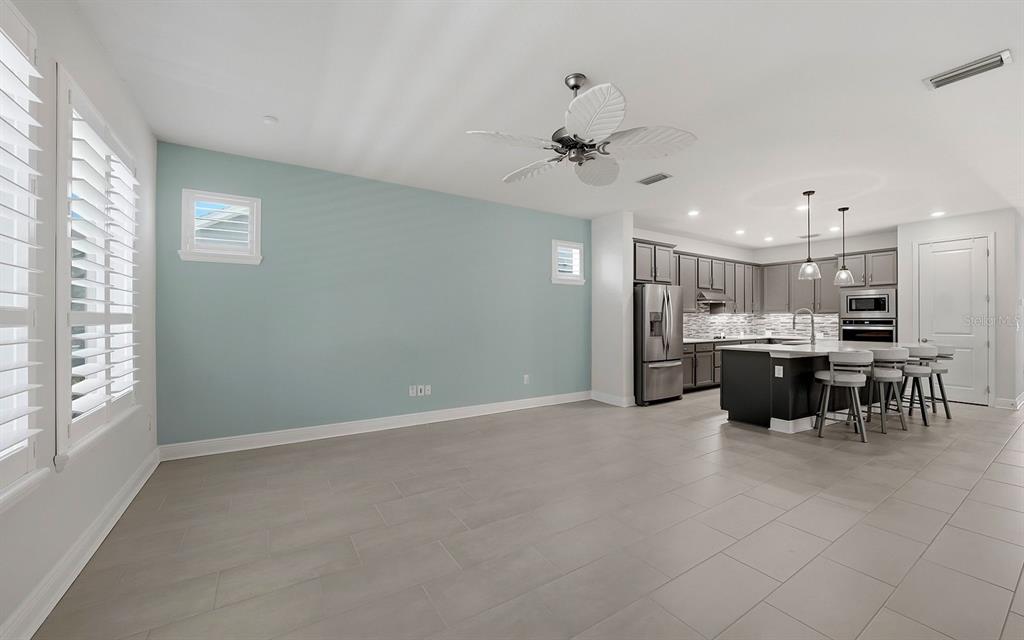 2535 Fireflag Lane Sarasota, FL 34232 - Photo 10 of 27 a kitchen with a refrigerator and a counter top space