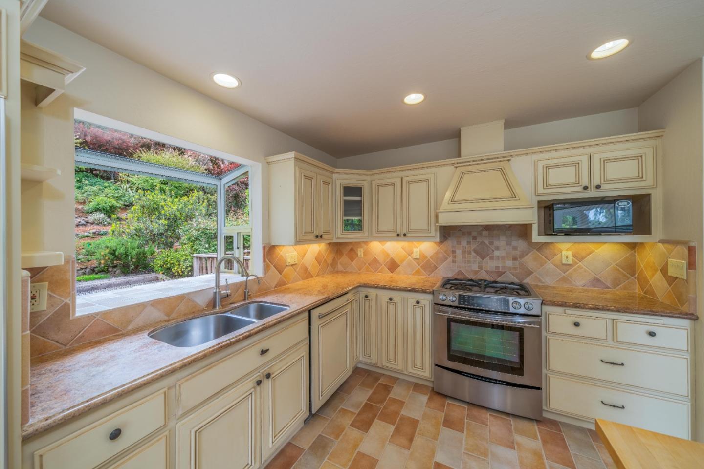 533 La Honda Drive Aptos, CA 95003 - Photo 16 of 44 a kitchen with granite countertop a sink stainless steel appliances and cabinets