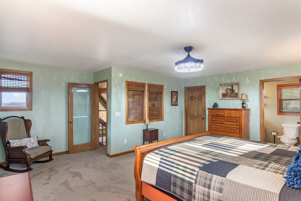 62 Trophy Buck Point Murphy, NC 28906 - Photo 20 of 46 a bedroom with a bed and a chandelier