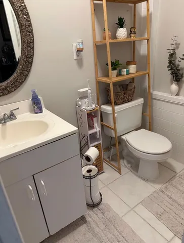 a bathroom with a sink toilet and mirror