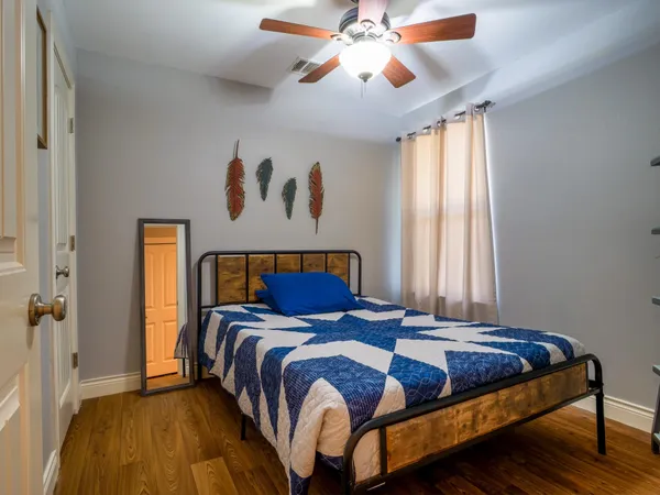 a bedroom with a bed and a chandelier