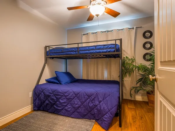 a bedroom with a bed and a mirror