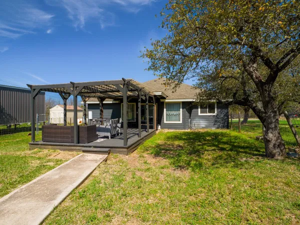 a view of a house with swimming pool and sitting area