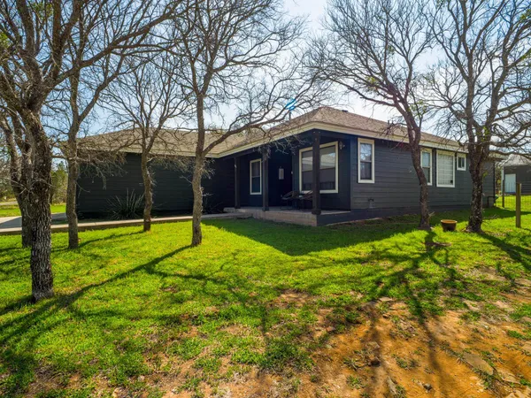 a view of a house with a backyard