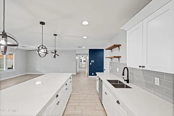 a kitchen with white cabinets and appliances
