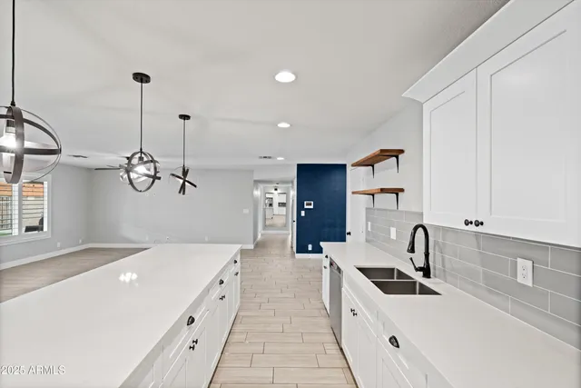 a kitchen with white cabinets and appliances