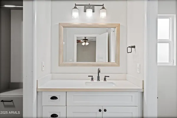 a bathroom with a sink toilet and mirror