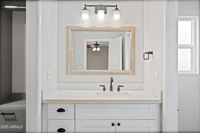 a bathroom with a sink toilet and mirror