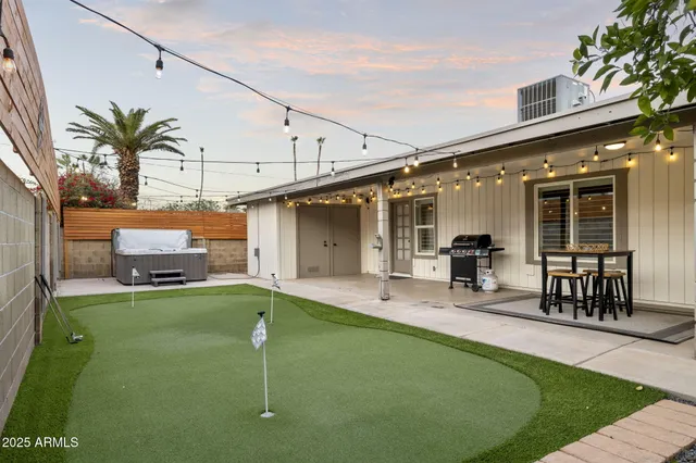 a swimming pool with outdoor seating and yard