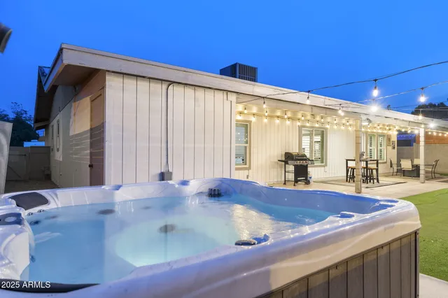 a large white kitchen with stainless steel appliances kitchen island granite countertop a sink and cabinets
