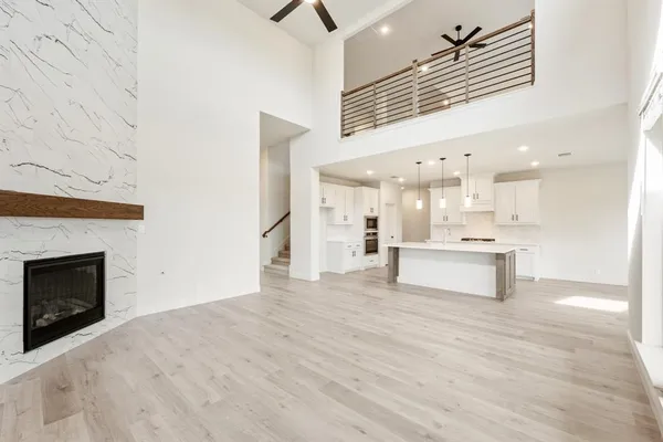 an empty room with ceiling fan and window