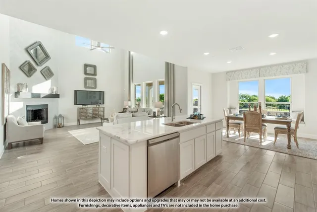 a large kitchen with kitchen island a sink table and chairs