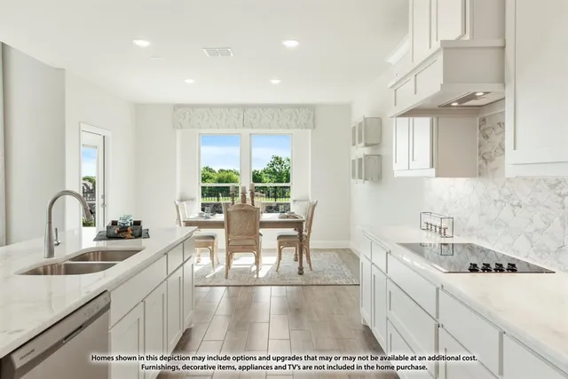 a kitchen with a sink a stove and cabinets