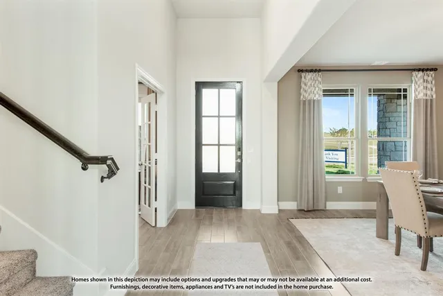 a view of a living room with furniture and windows