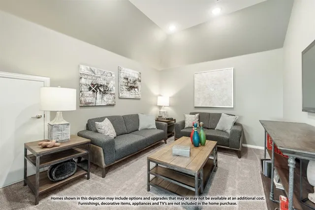 a living room with furniture a rug and a table