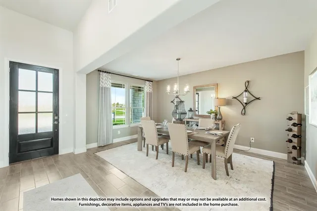 a dining room with a table chairs and a living room view
