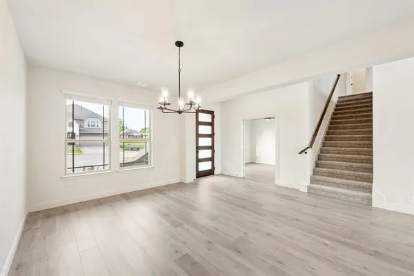 a view of an empty room with a fireplace and a window