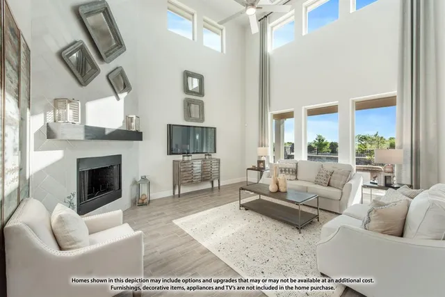a living room with furniture large window and a fireplace