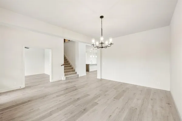 a kitchen with stainless steel appliances kitchen island a sink a stove a refrigerator and white cabinets