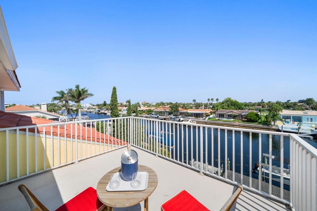 3339 Seaway Drive New Port Richey, FL 34652 - Photo 12 of 48 a balcony with wooden floor table and chairs
