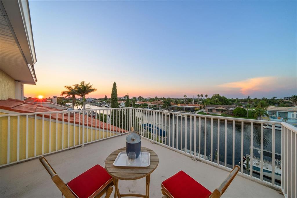 3339 Seaway Drive New Port Richey, FL 34652 - Photo 13 of 48 a balcony with wooden floor table and chairs
