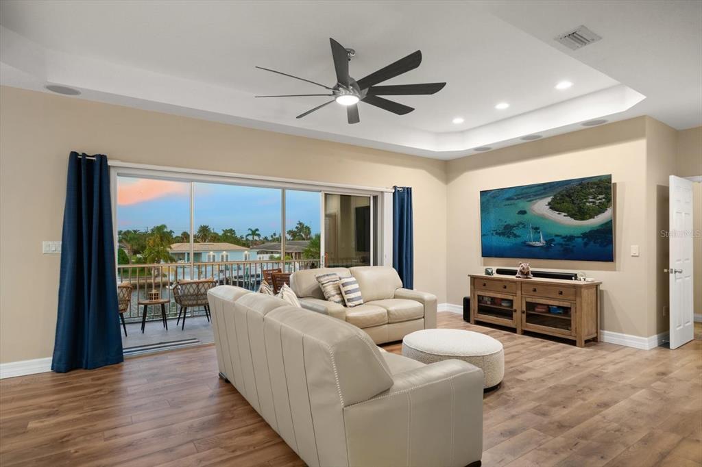 3339 Seaway Drive New Port Richey, FL 34652 - Photo 19 of 48 a living room with furniture tv and a floor to ceiling window