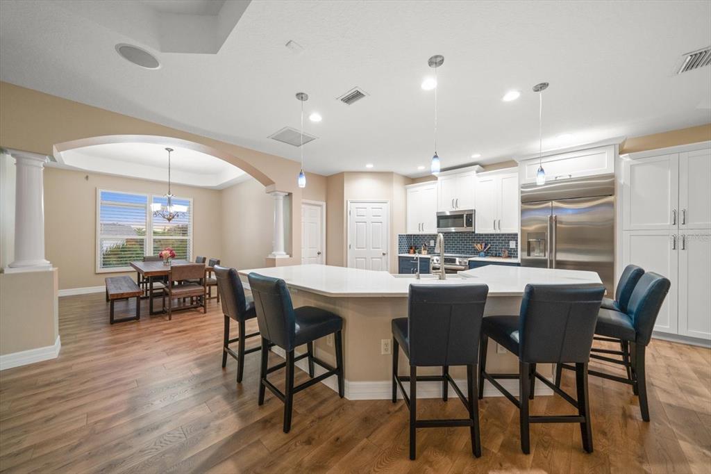 3339 Seaway Drive New Port Richey, FL 34652 - Photo 23 of 48 a dining hall with stainless steel appliances a dining table and chairs