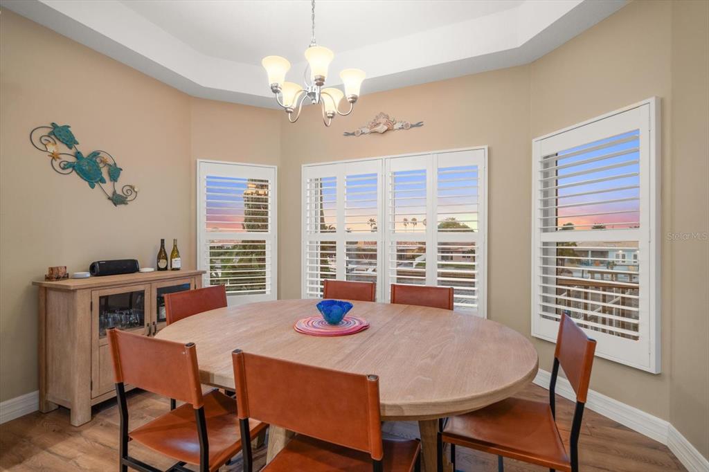 3339 Seaway Drive New Port Richey, FL 34652 - Photo 25 of 48 a view of a dining room with furniture a chandelier and wooden floor