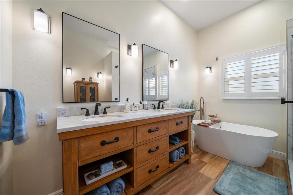 3339 Seaway Drive New Port Richey, FL 34652 - Photo 33 of 48 a spacious bathroom with a double vanity sink mirror and bathtub