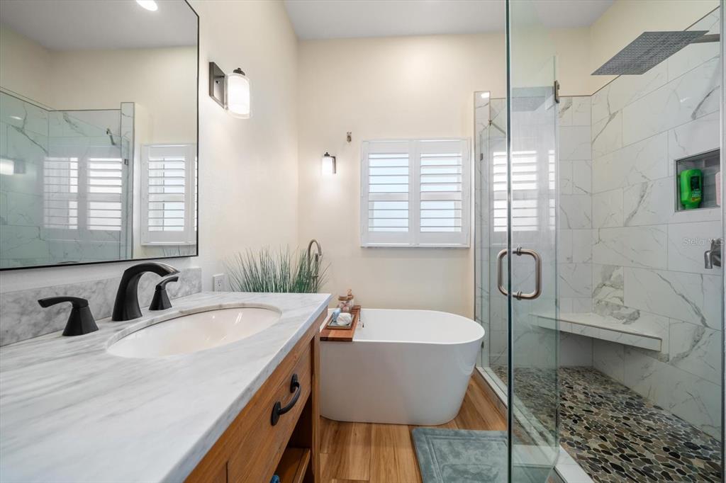 3339 Seaway Drive New Port Richey, FL 34652 - Photo 34 of 48 a bathroom with a double vanity sink a mirror and a bathtub