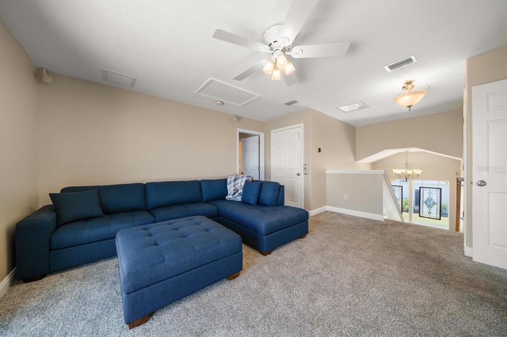 3339 Seaway Drive New Port Richey, FL 34652 - Photo 35 of 48 a living room with furniture and a chandelier