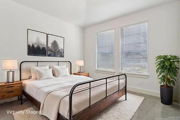 a bedroom with furniture and a window
