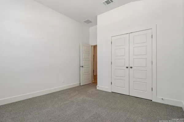 an empty room with closet area